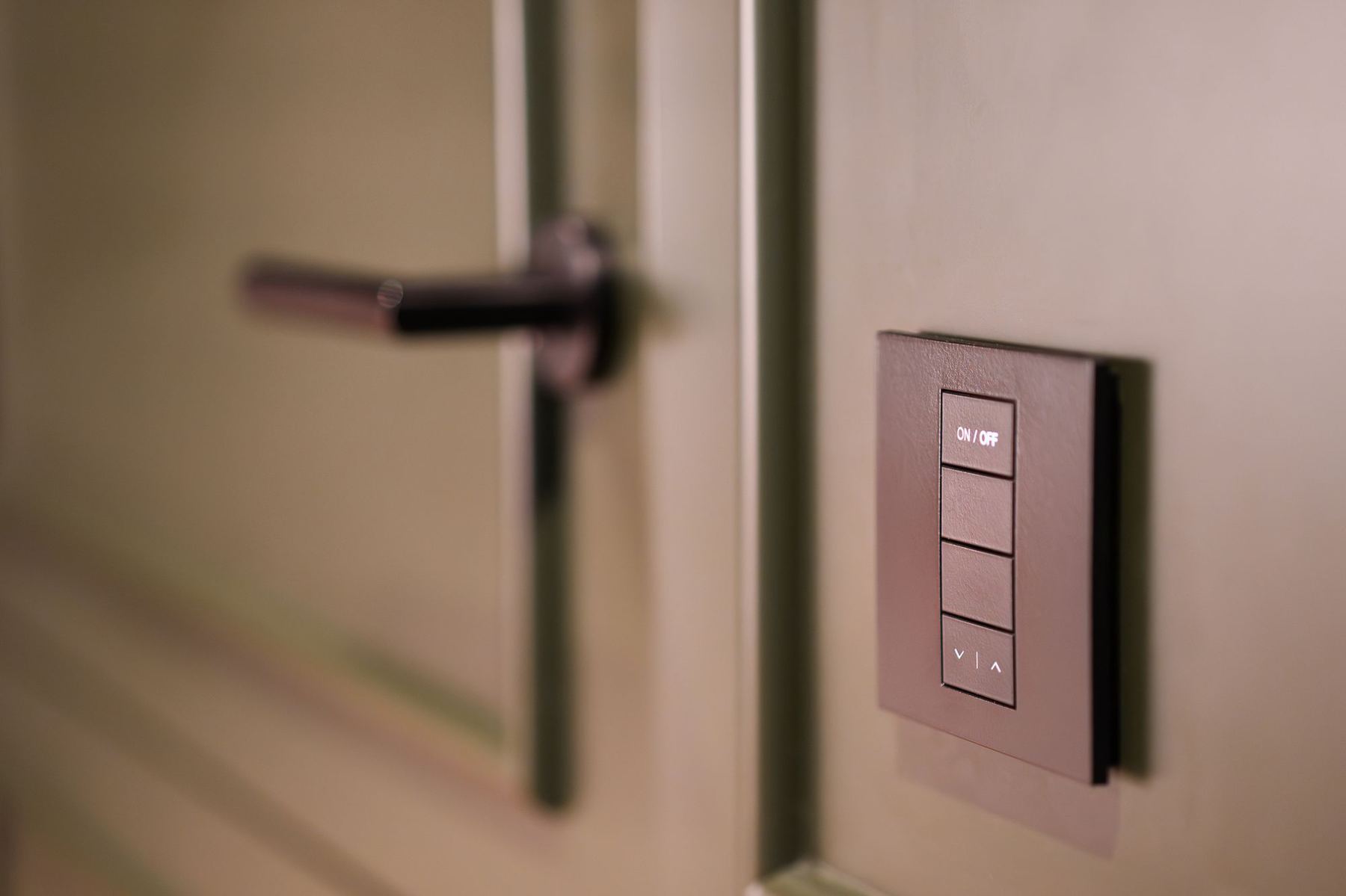 Discrete smart lighting keypad beside a door